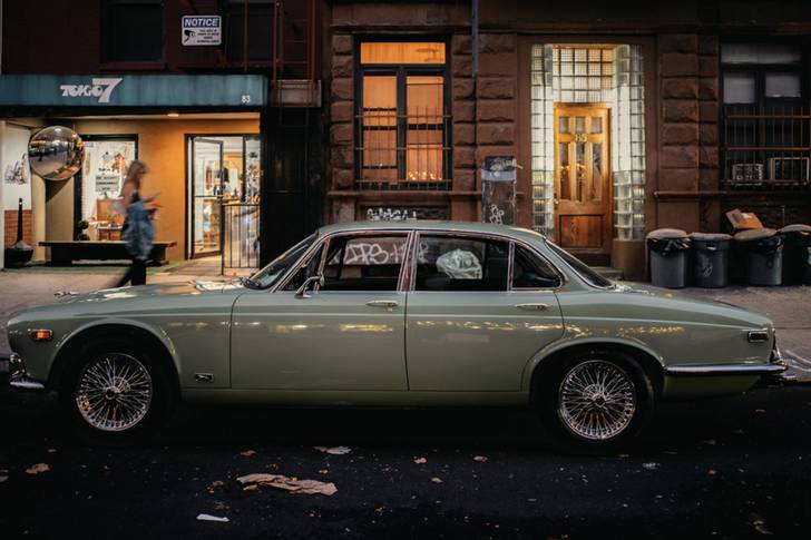 an old Jaguar parked on a Manhattan street